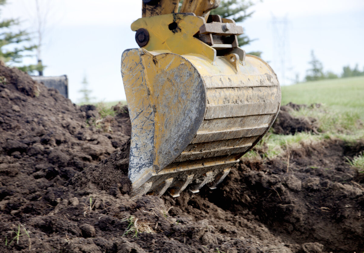 A backhoe and pile of dirt