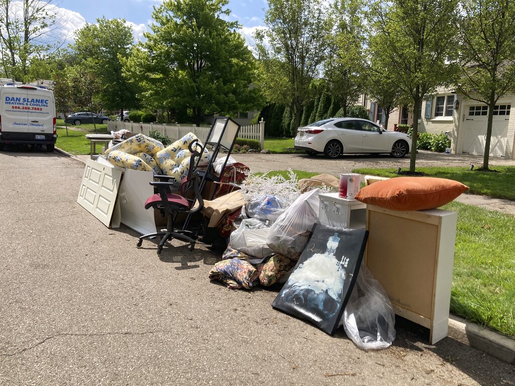 Trash is shown on a street in Grosse Pointe Farms, Mich., Sunday, June 27, 2021.