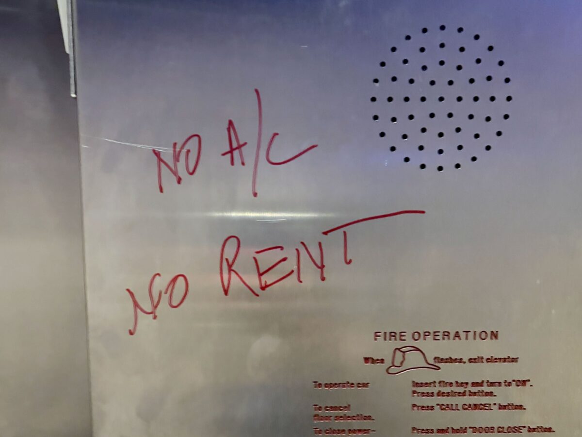 "No A/C, No Rent" is written in red on an elevator wall at Riverfront Towers in Detroit.
