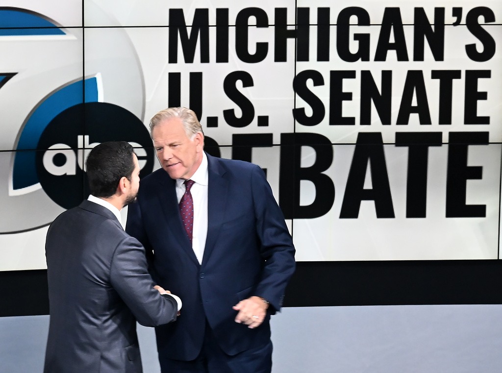 Mike Rogers, Abdul El-Sayed shake hands at debate.